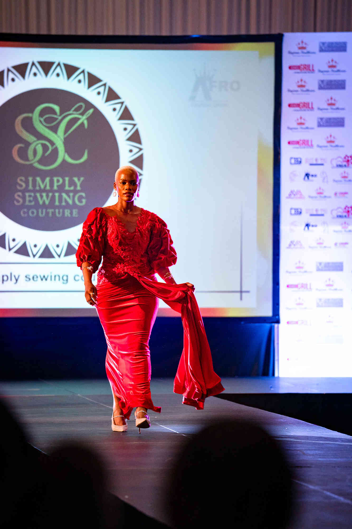 AfroFashion Week runway showcase 7: Model wearing couture fashion design